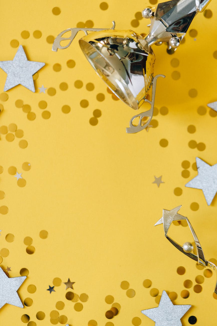 golden trophy and silver stars on yellow background