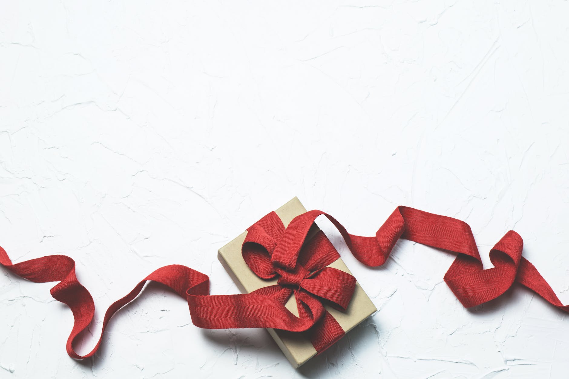 red and white gift box with ribbon bow