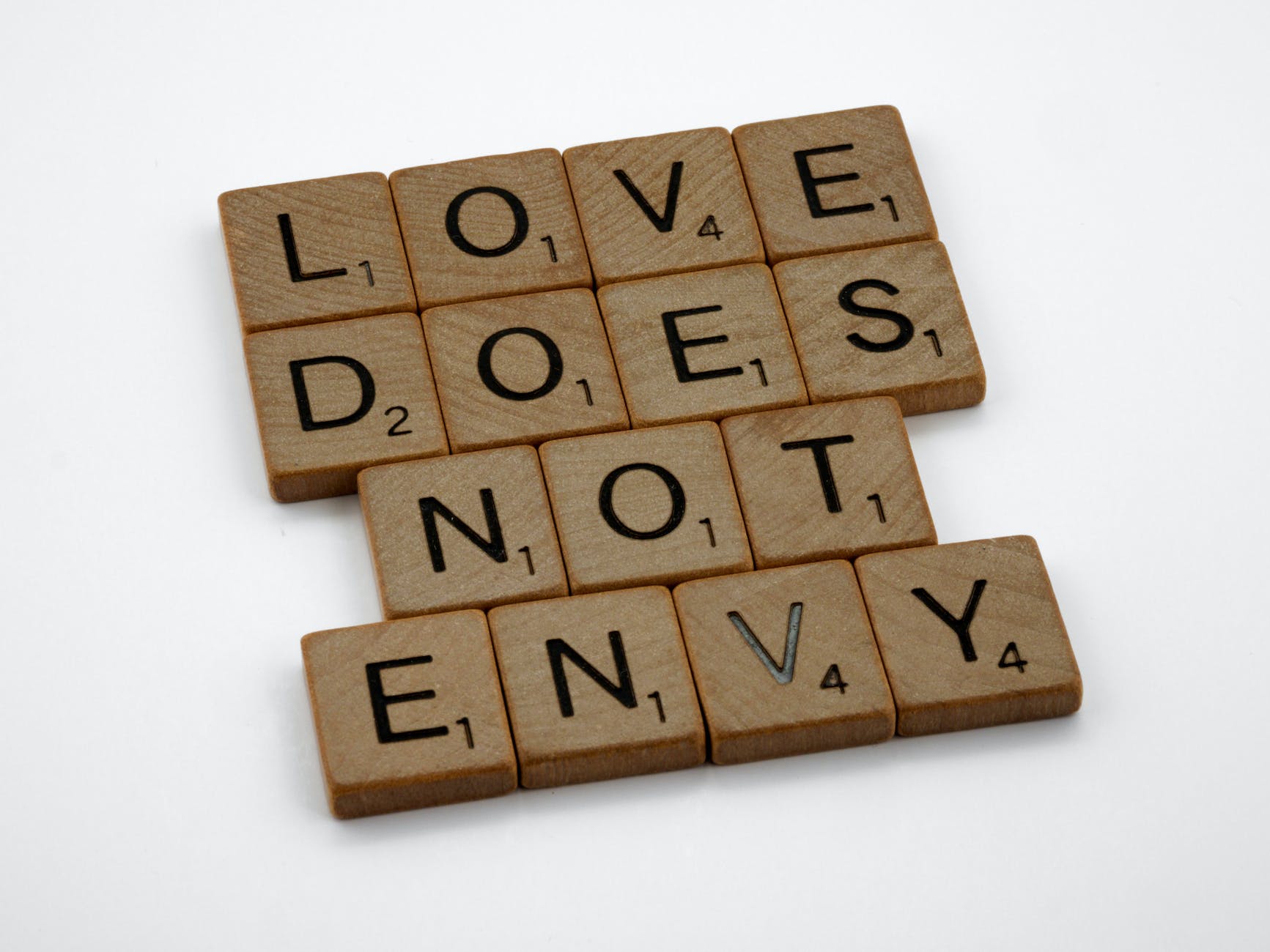 close up shot of scrabble tiles on a white surface