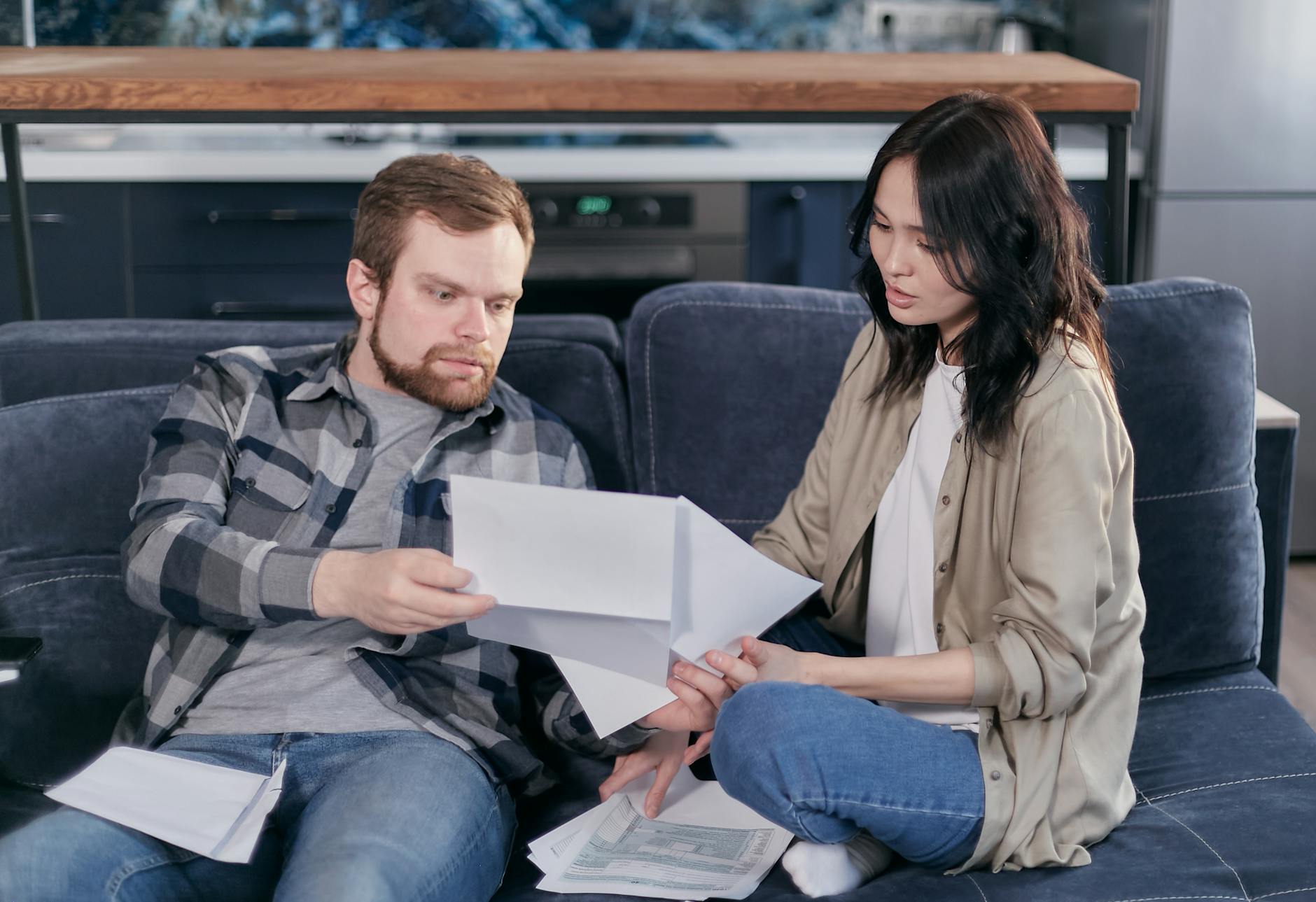 a man and a woman checking on some tax forms